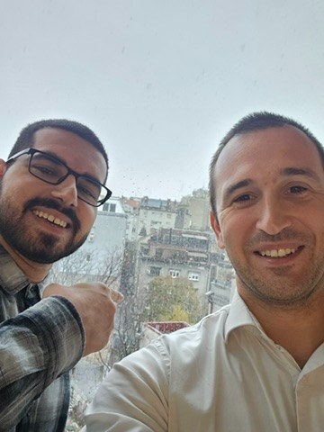 Tanishpreet smiling with a colleague